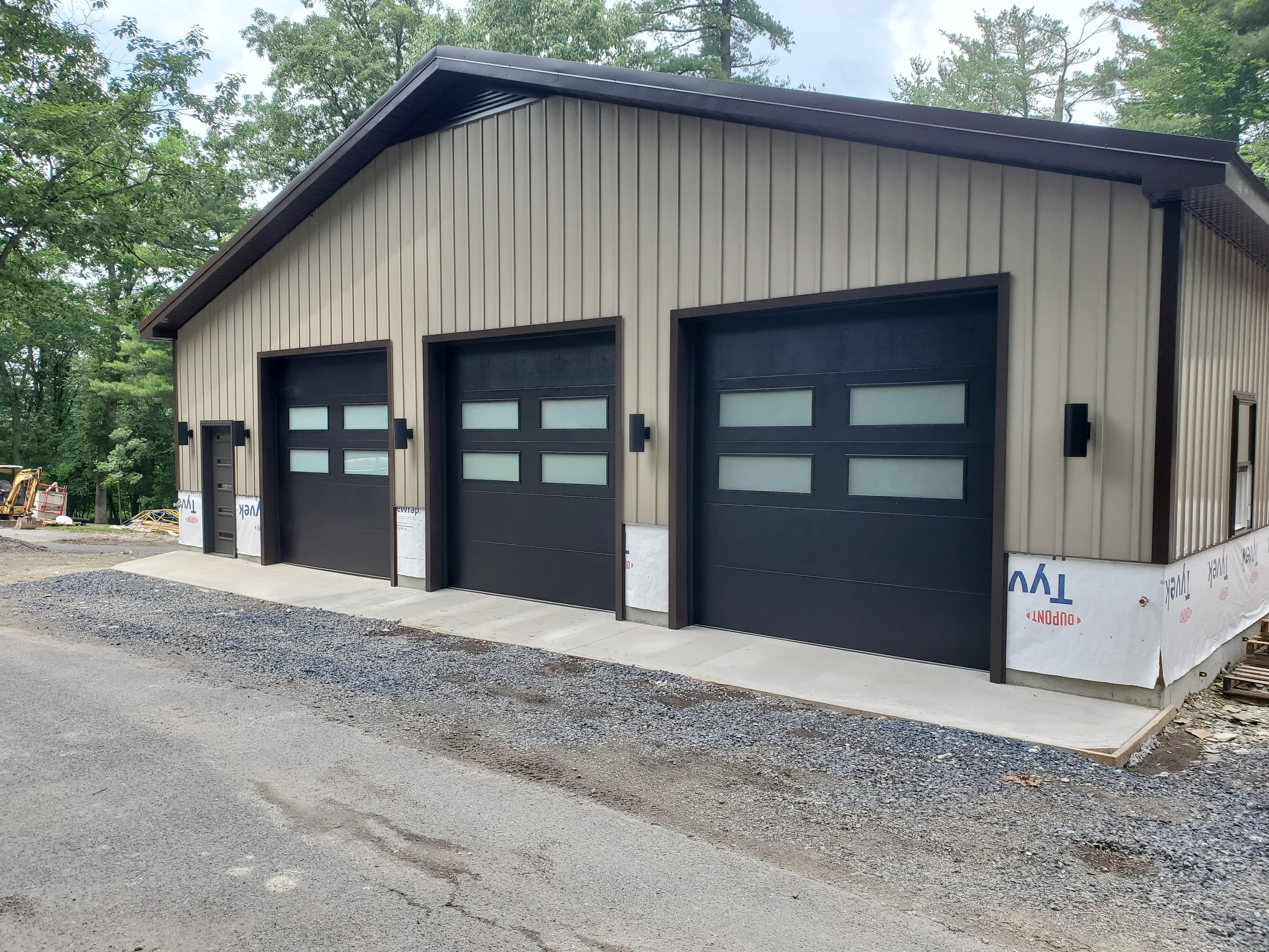 Three-bay commercial building with black windowed sectional doors