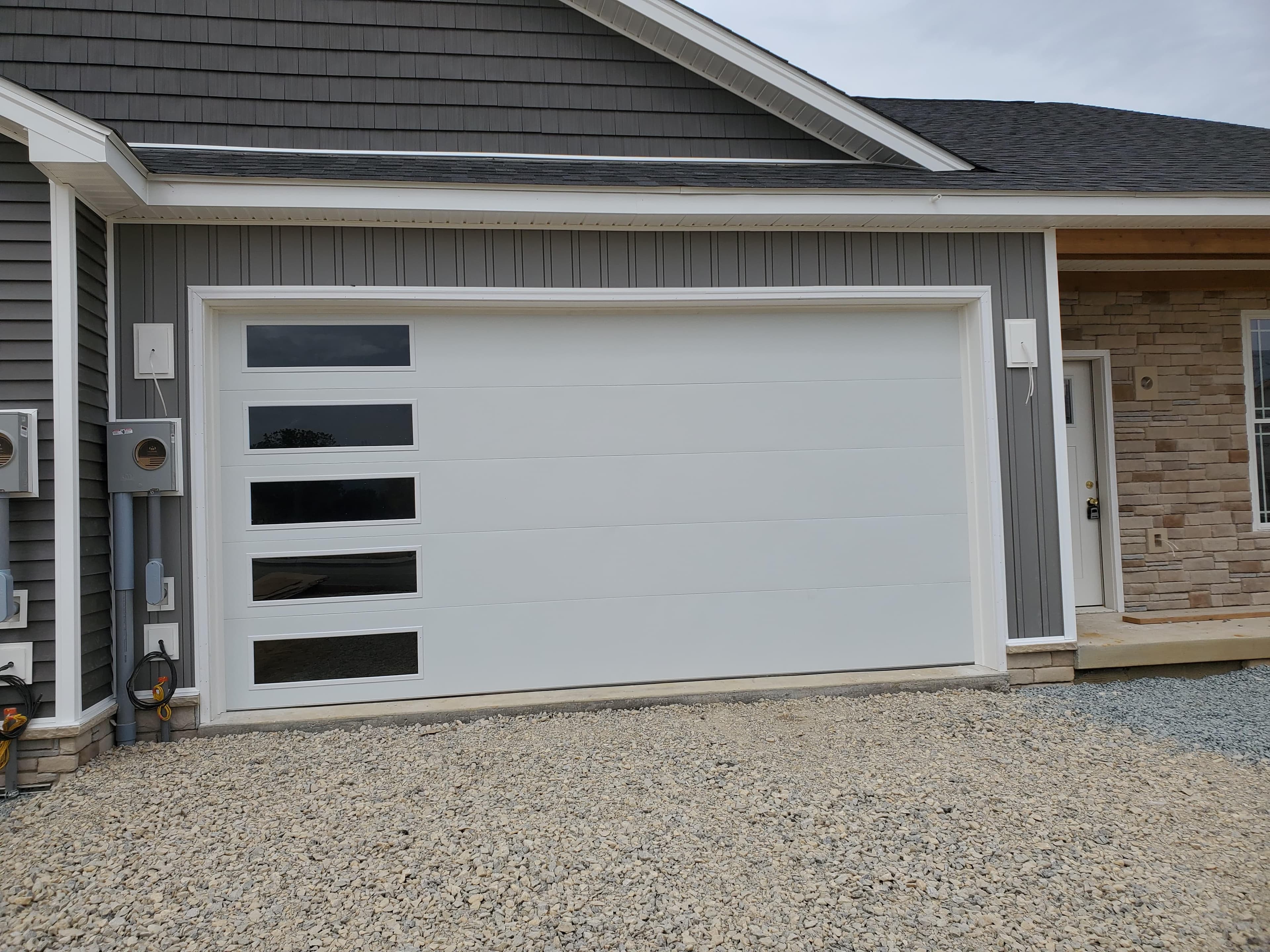 Modern flush garage door with a horizontal window band