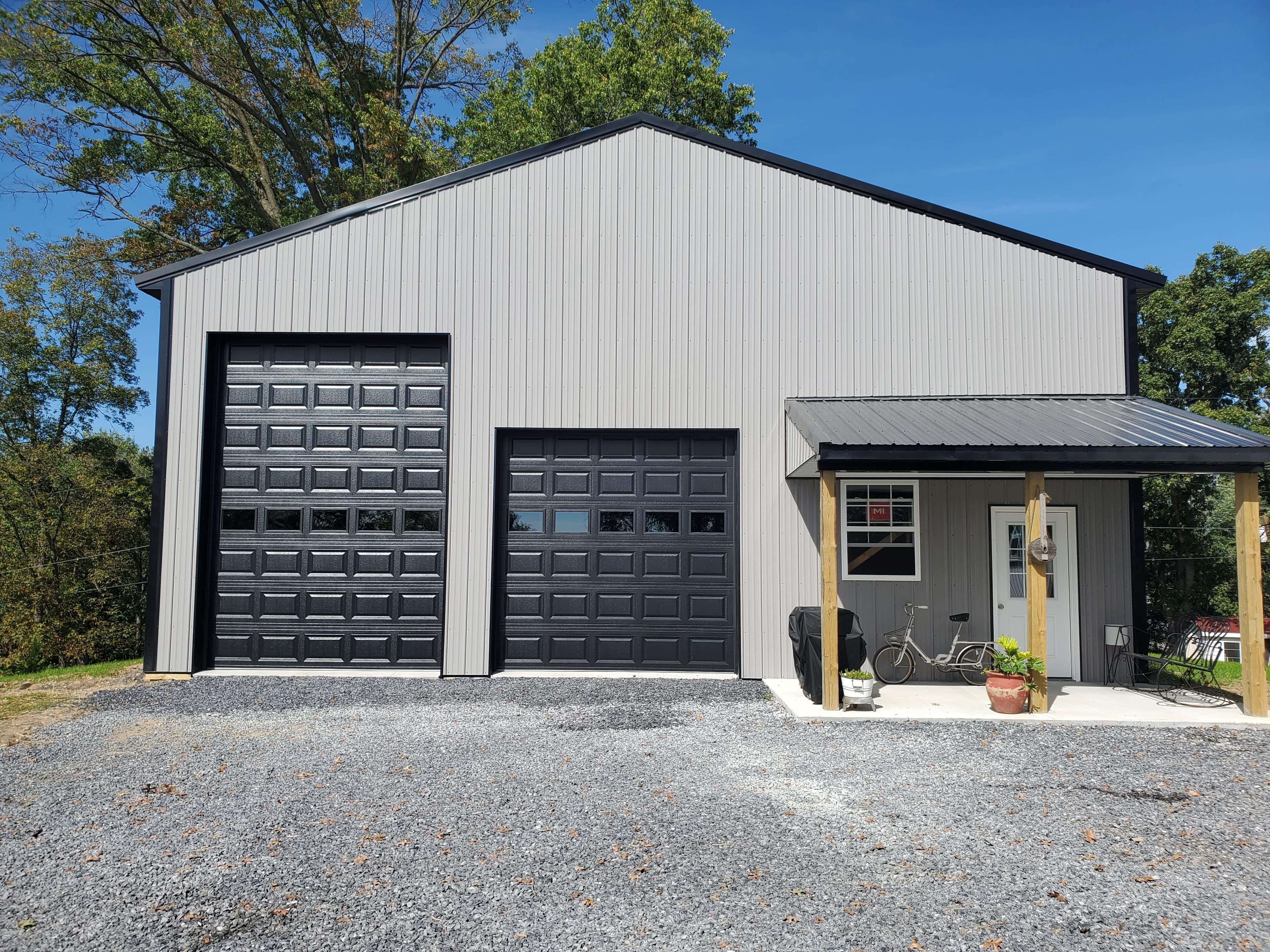 Agricultural pole building with black sectional garage doors