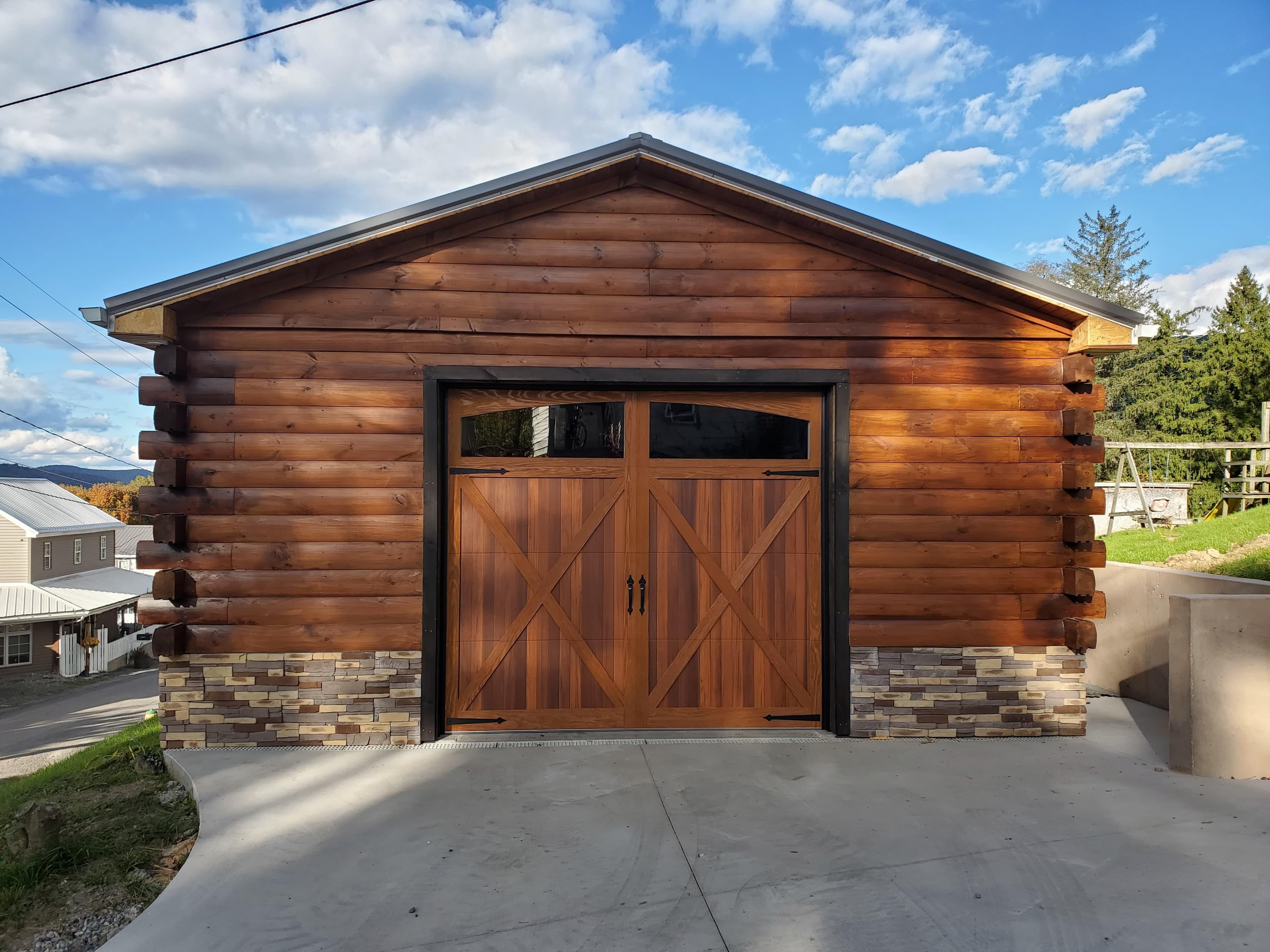 Wood carriage-style garage door on a log cabin